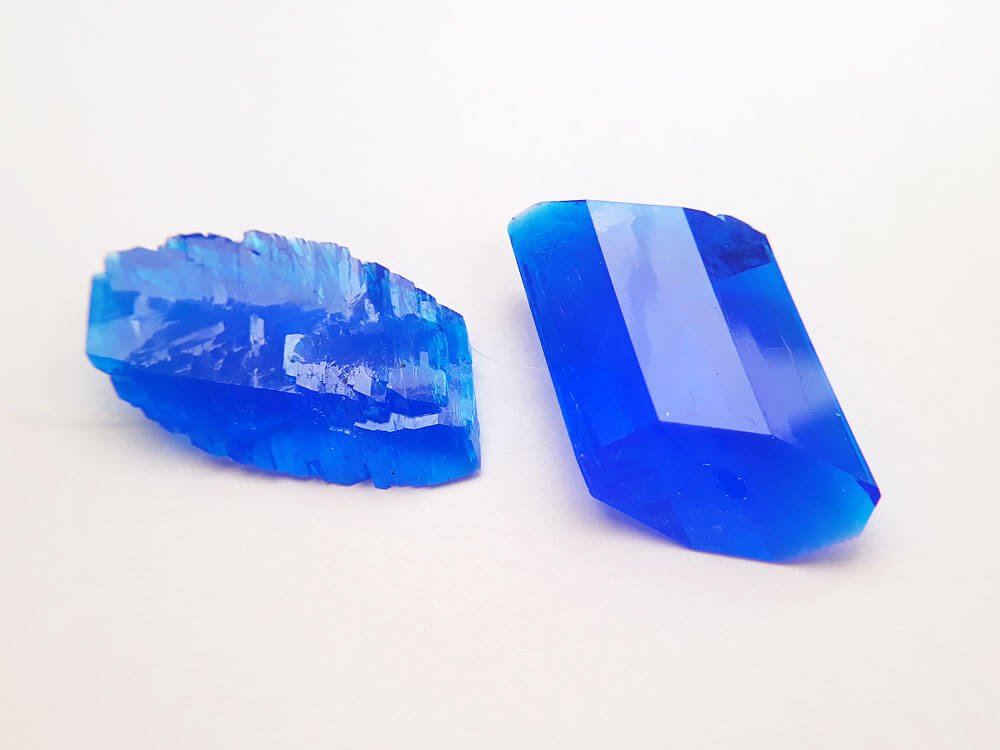 A copper sulfate crystal grown in an impure solution vs a pure one.