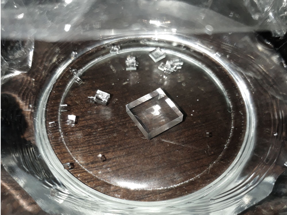 a large sodium chloride crystal growing in a dish